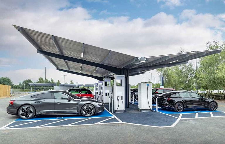 Electric vehicles at battery charging station.