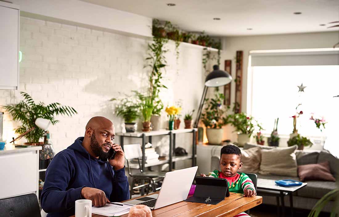 Parent on the phone with financial advisor to discuss their financial plan.