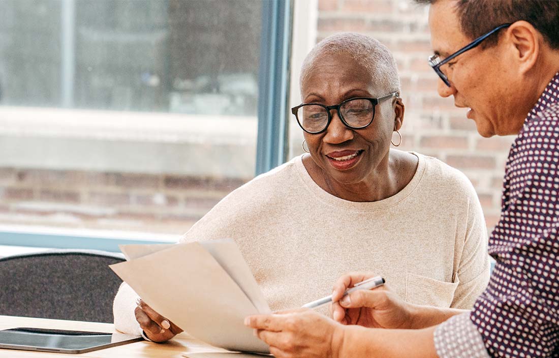 Elderly couple assessing insurance agencies together.