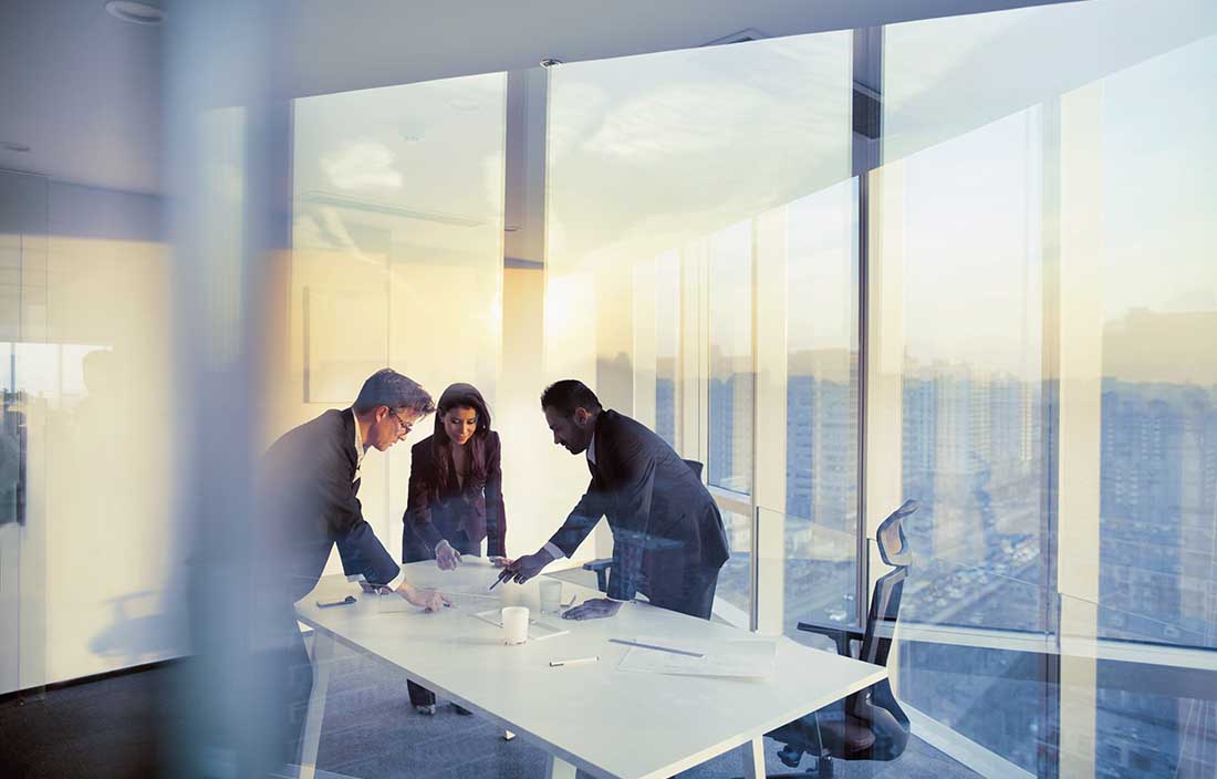 Business professionals in a modern conference room discussing regulations on foreign tax credits.