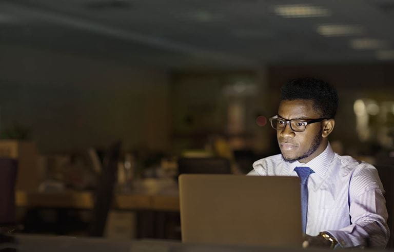 Business professional working in office at night.