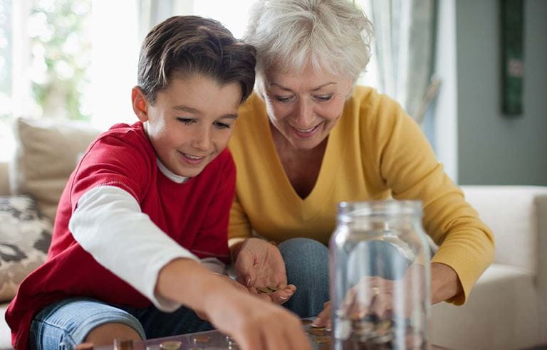 Grandparent teaching their grandchild about finances.