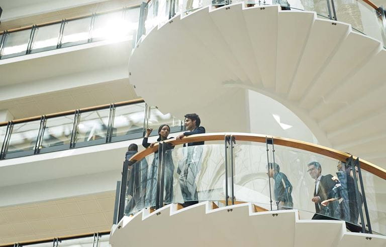 Business professionals on a staircase discussing the Inflation Reduction Act.