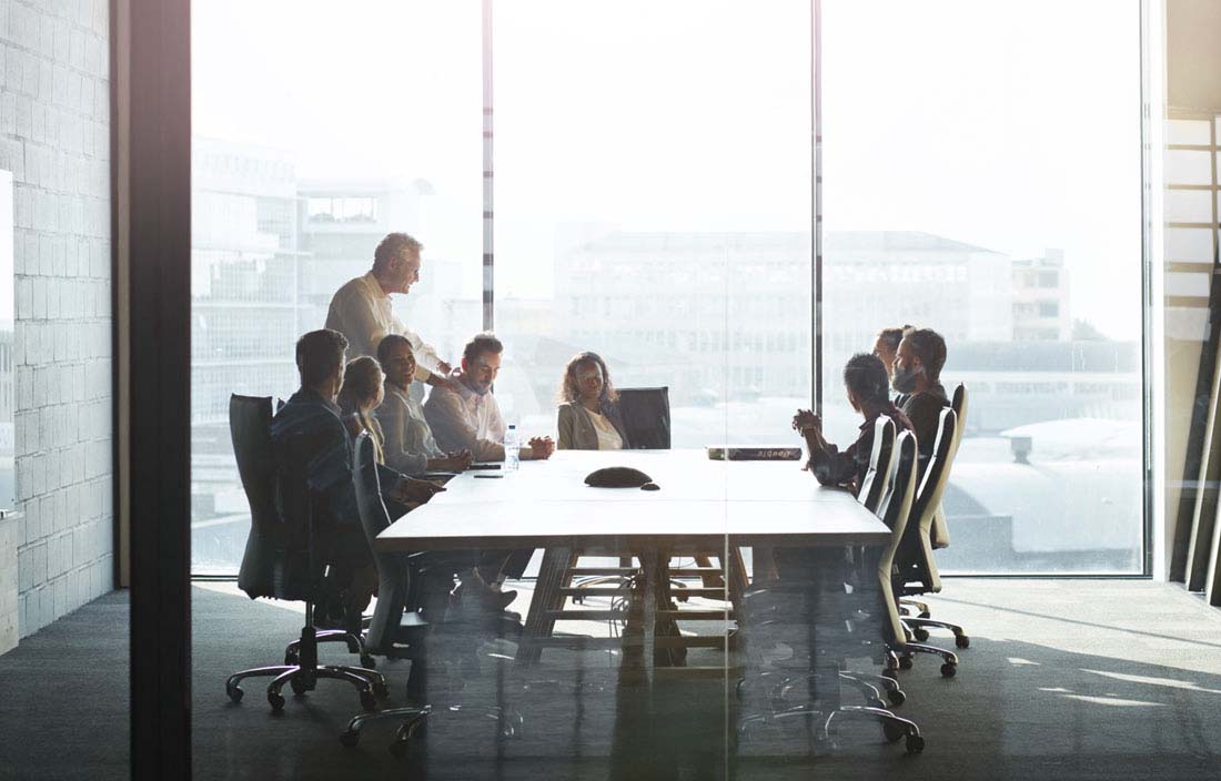 Business professionals in a modern conference room discussing international tax updates.