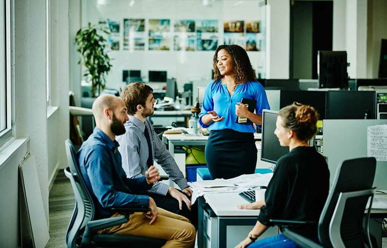 Business professionals in a modern conference room discussing a pass-through entity tax.