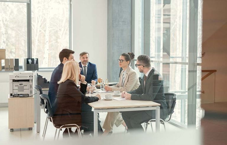 Private fund advisors discussing SECs regulation reform in a conference room.