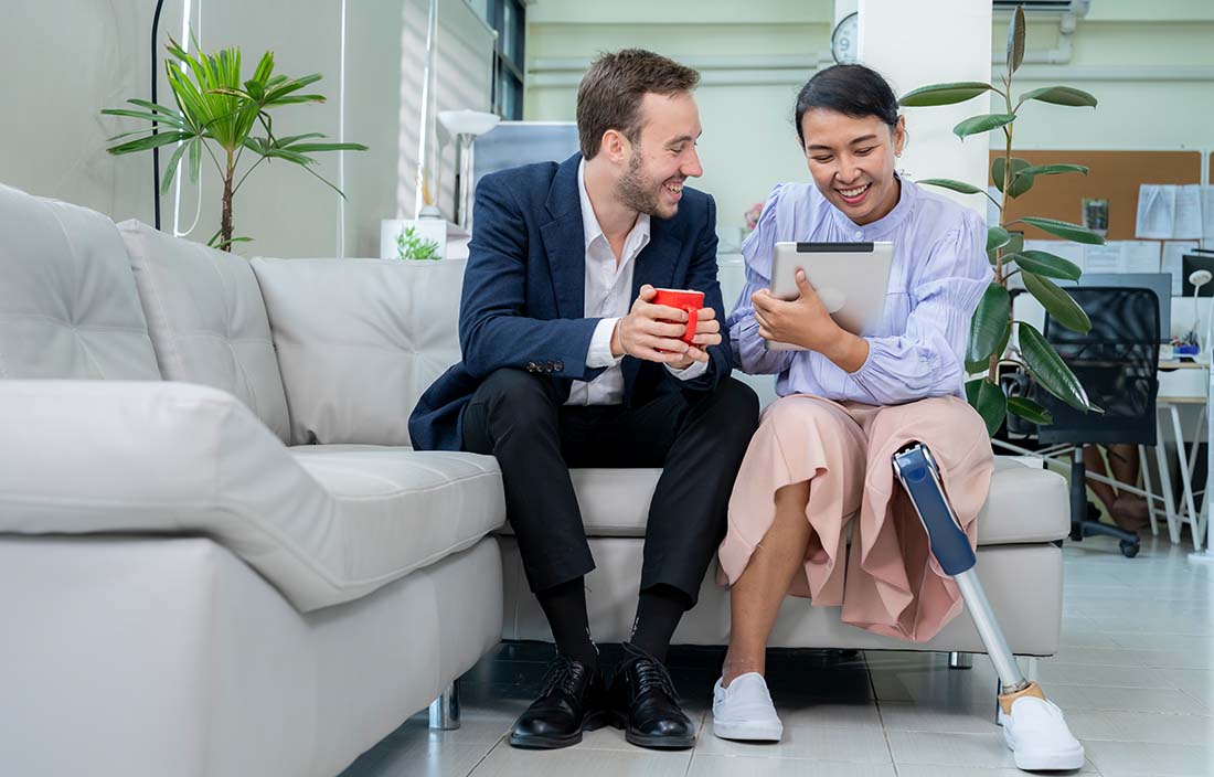 Two business professionals sitting on a couch learning about state and local tax.