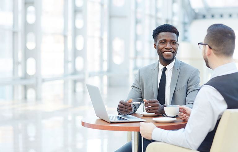 Two business professionals discussing family offices.