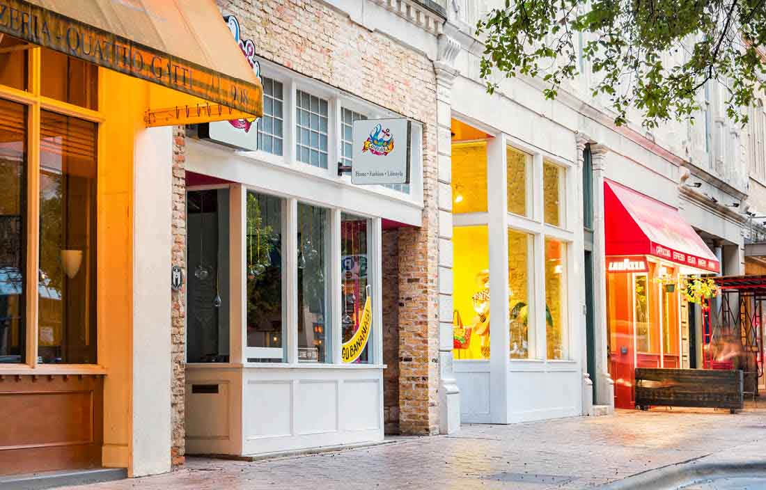 Brightly lit storefronts.