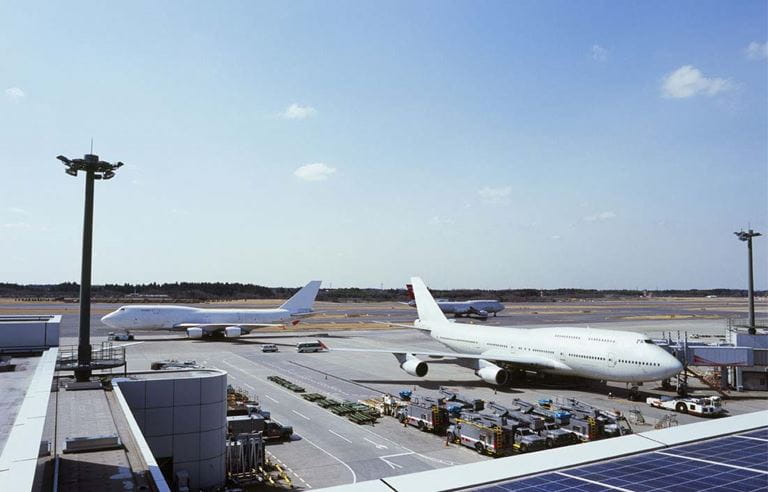 Airplanes taxiing at airport.