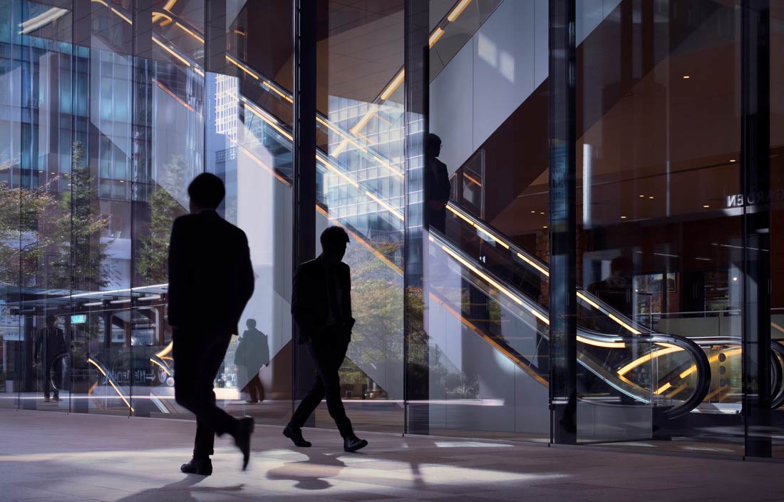 Business professionals walking in a modern office building.