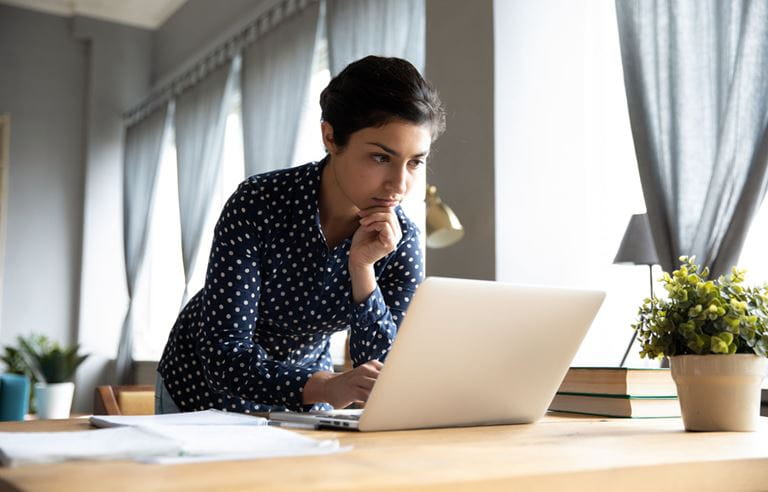 Healthcare professional reading about 1099 compliance on their laptop.