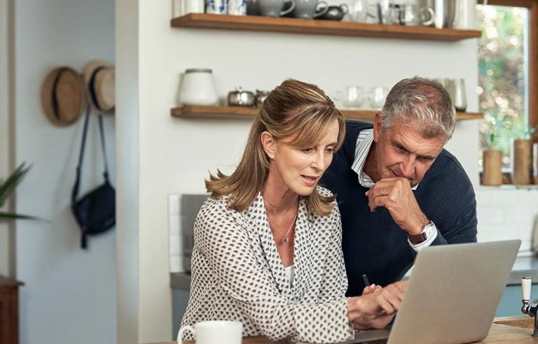 Couple on their laptop computer planning for their year end finances.