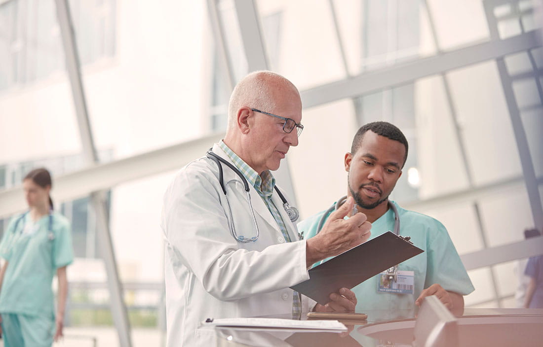 Doctor and male nurse going over a patient's chart inside a hospital