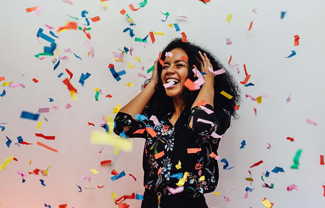 Woman celebrating with confetti.