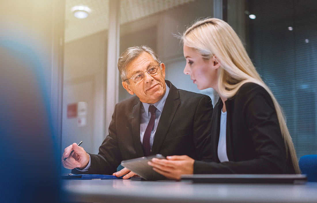 Healthcare CFOs in a modern conference room discussing how to manage risk.