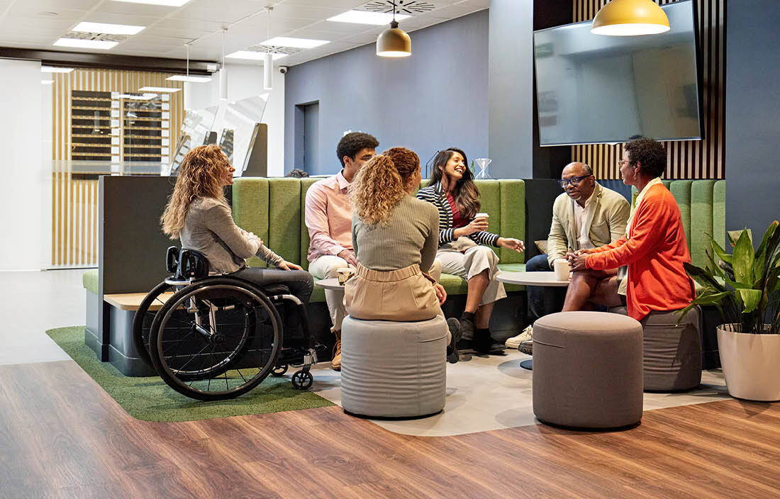 Business professionals meeting in a lounge area having an informal discussion