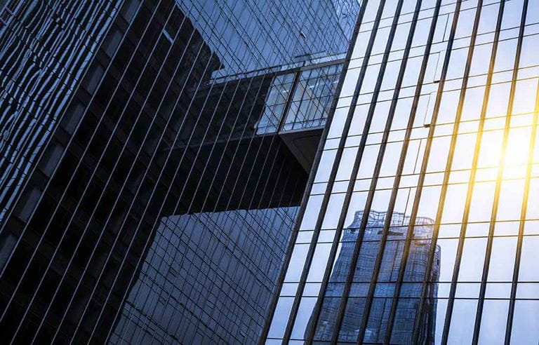 Sun shining in the reflection of a glass building.