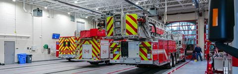 Commerce Township Fire Department view of fire trucks from the rear in the fire truck vehicle garage.