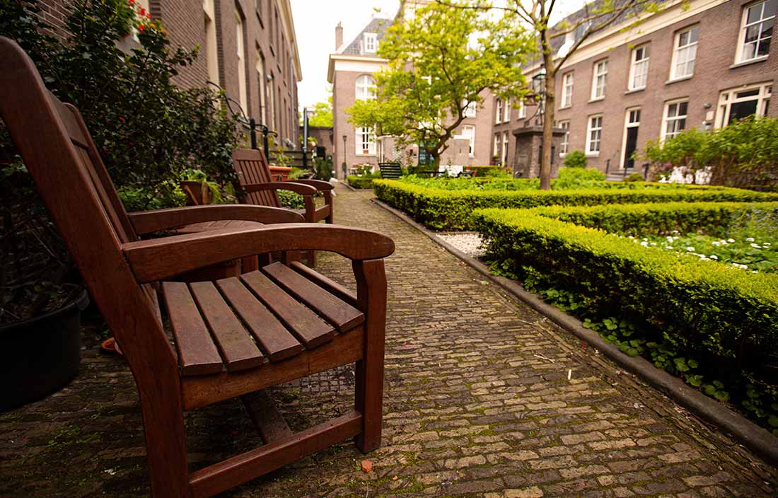 Exterior grounds of religious congregation's home, with close-up of bench and residences