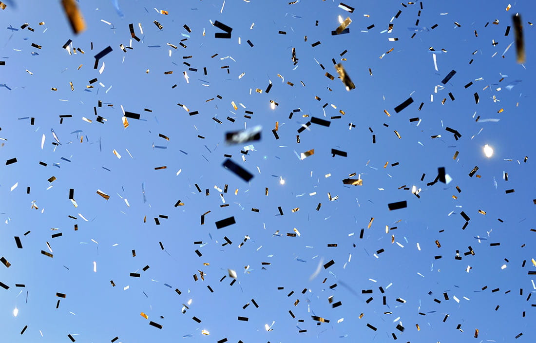 Confetti against a blue sky background