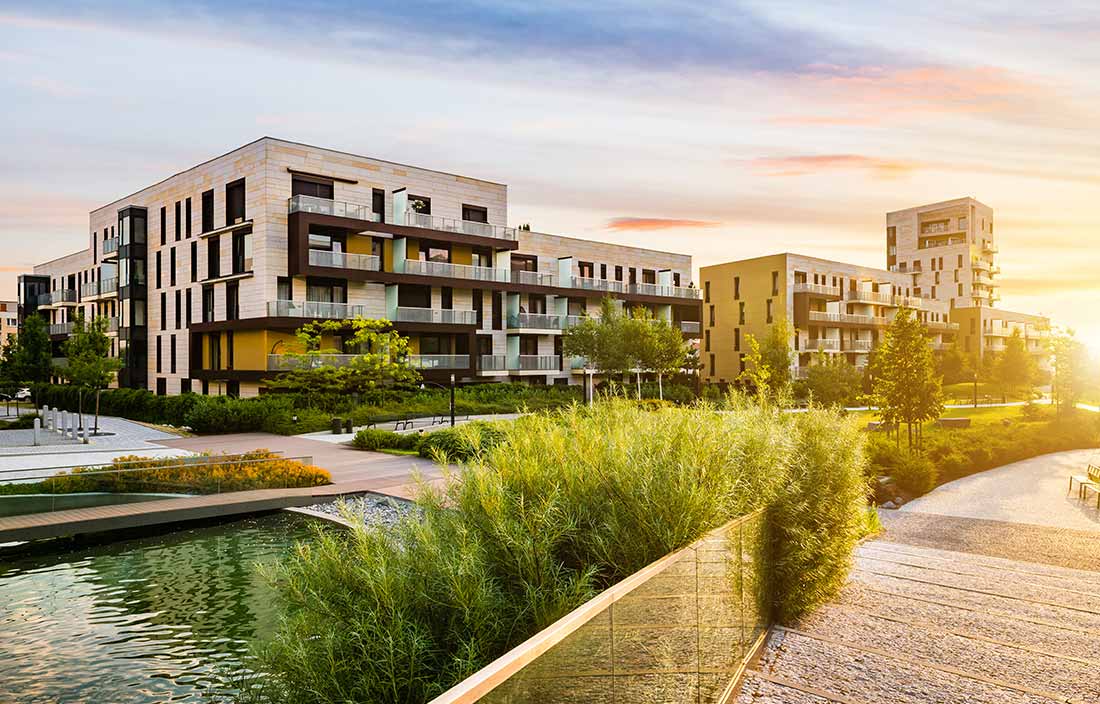 Residential development in the public green park during sunrise