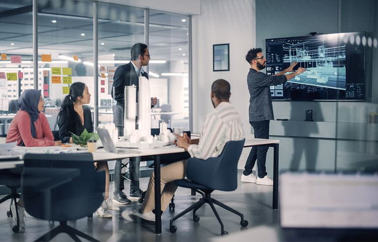 Modern Multi-Ethnic Architectural Agency Office Meeting. Group of Professional Architects, Designers, Developers, Investors Use TV with 3D Building Model to Design Sustainable Housing Project