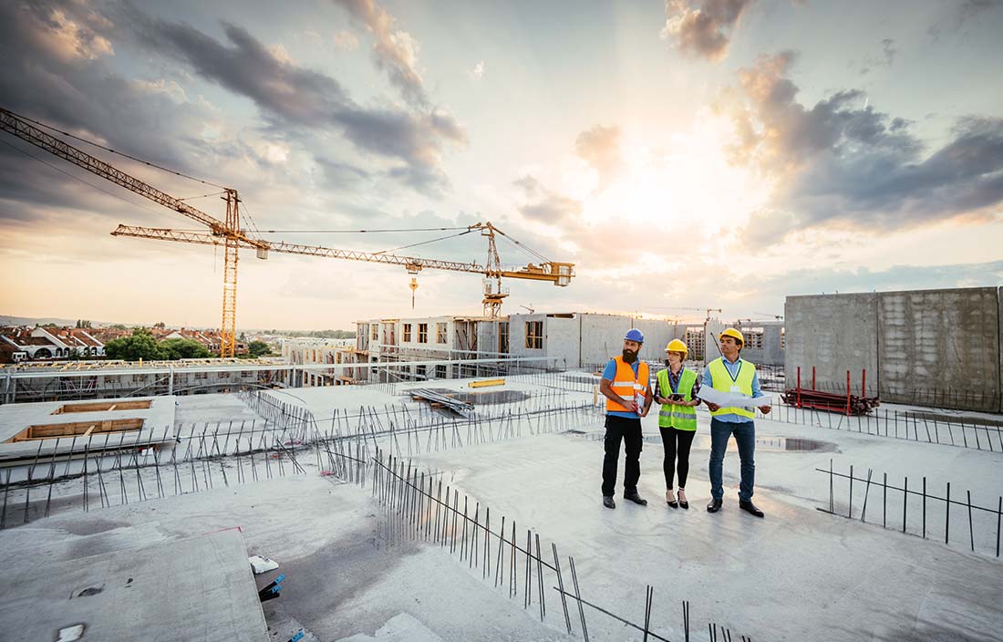 Development consultants reassessing a project on a construction site