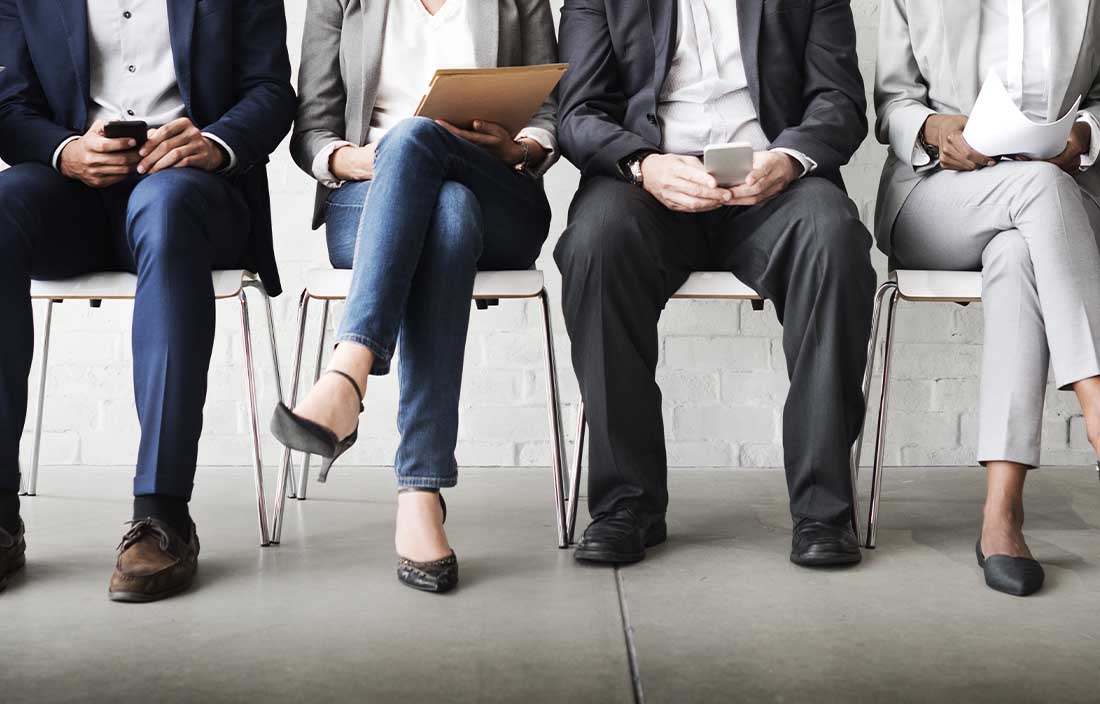 Bottom half of People sitting in chairs waiting to discuss employment situation data