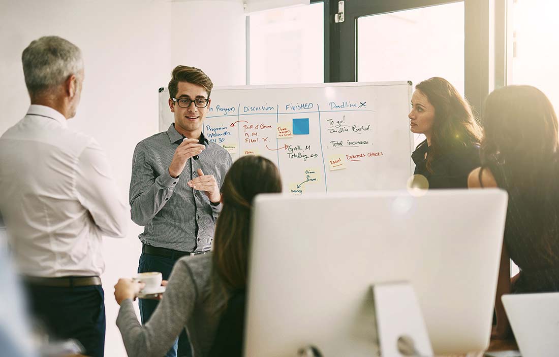 Group of people having a strategy session in an office setting.