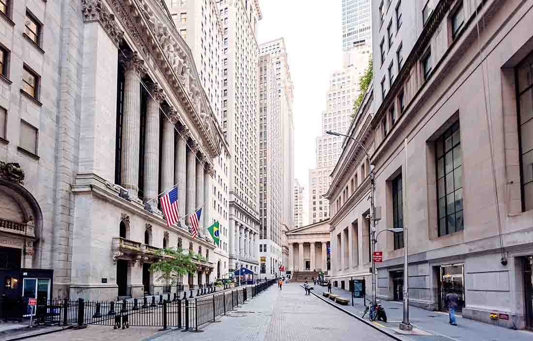 A downtown street view with buildings on the left and right with very historical architecture. 