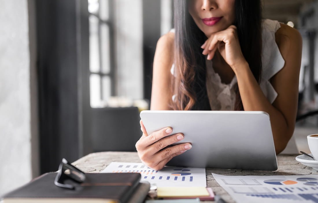 Businessperson using a laptop at a table.