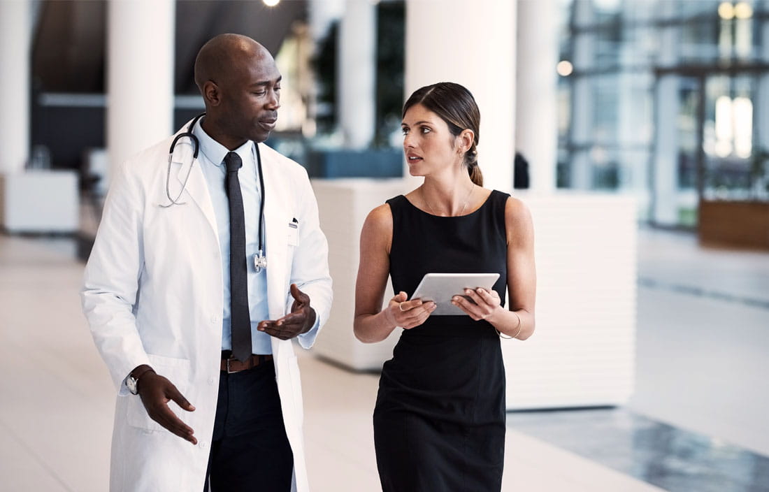 Doctor walking with another colleague.