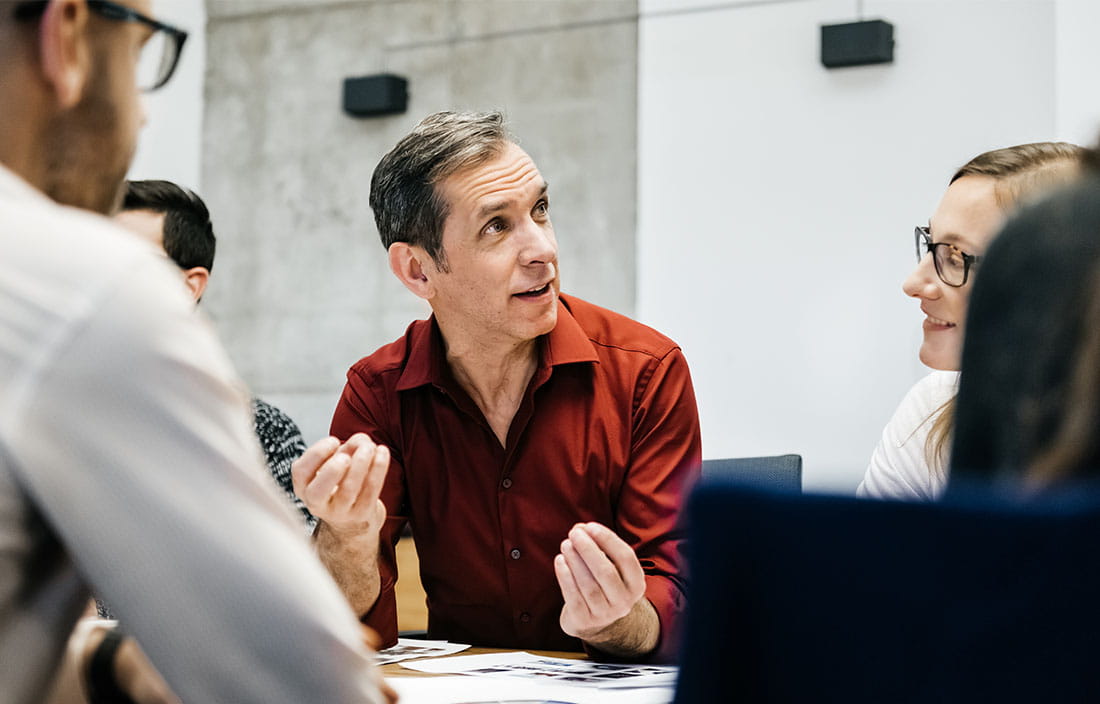 Business professional in a conference room having a meeting.